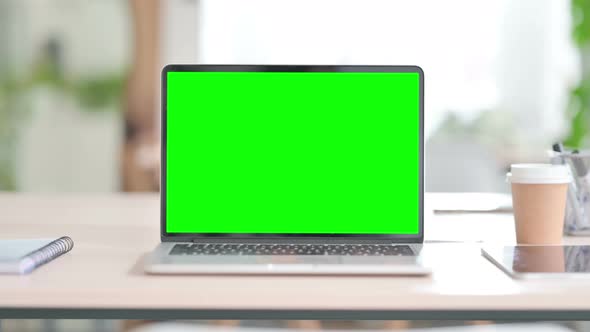 Laptop with Green Screen in Office