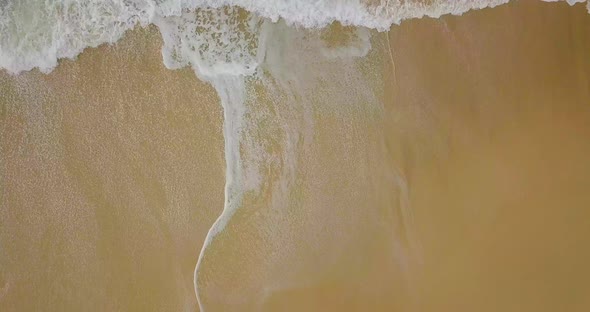 Slow flight over isolated beach and waves in wild colorful ocean, Australia