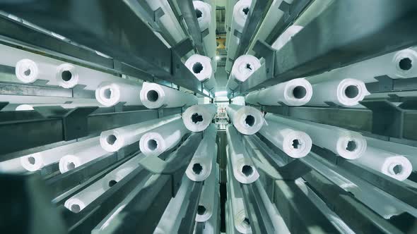 Close Up View of Paper Rolls Moving Vertically at a Paper Factory