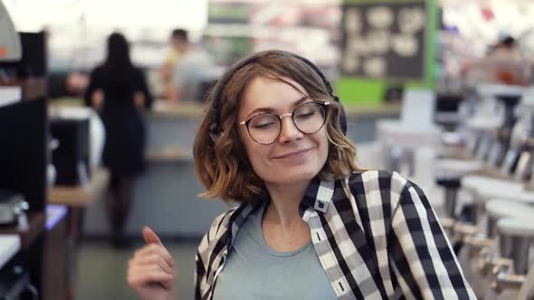 Portrait of Cute Caucasian Pretty Young Woman with Short Curly Hair Plaid Shirt and in Headphones