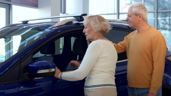 Senior Couple Chooses Car at the Dealership