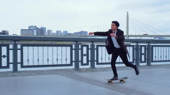Boy Practicing Skateboarding on Embankment