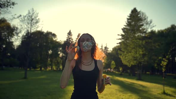 Young Woman Playing with Soap Bubbles, Outdoor Having Fun