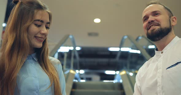 Portrait of an Attractive Young Couple on an Escalator