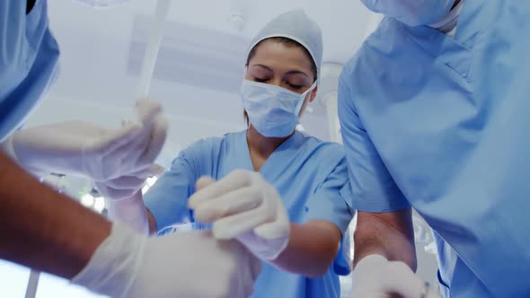 Surgery team operating a patient in an operating room