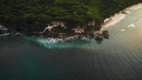 Beautiful Bingin beach with exotic cliffs houses and hotel located in Bali, Indonesia. This drone fo