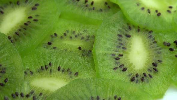 Background in the Form of Sliced Kiwi Spins Juicy Green Kiwi Fruit or Chinese Gooseberry