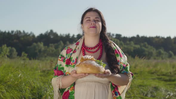 Portrait of Beautiful Overweight Woman Proposing Lard on the Loaf of White Bread Smiling