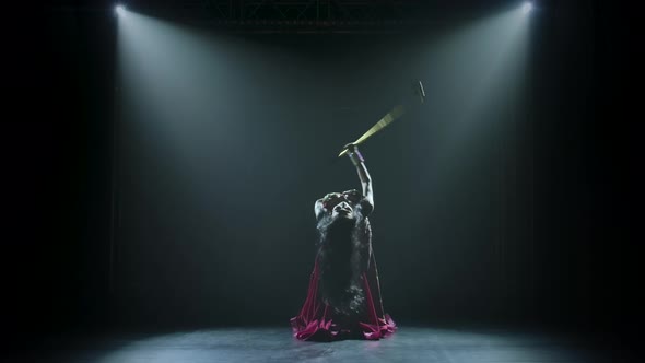 Alluring Traditional Oriental Belly Dancer Girl Dancing with a Golden Cane on Neon Lighting