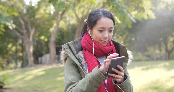 Woman use of mobile phone in citypark