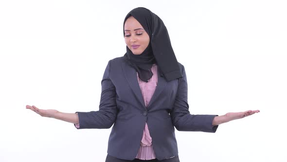 Happy Young African Muslim Businesswoman Comparing Something