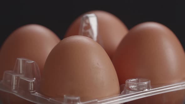 Row Of Delicious Chicken Eggs Rotating Over Dark Background