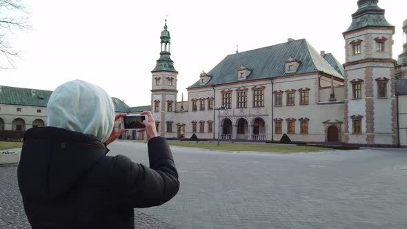 Girl Tourist Makes a Photos of Old Palace