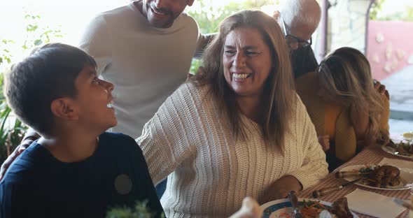 Happy latin family having fun eating together at vintage restaurant