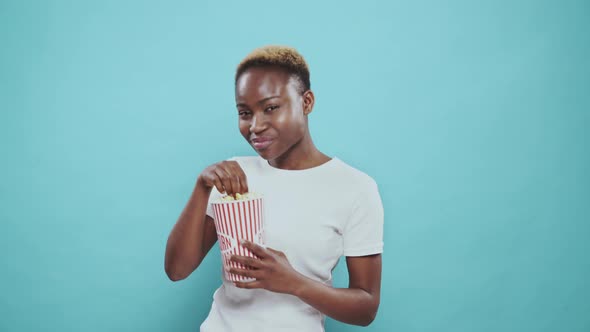 Beautiful Young Afro Girl Enjoying Tasty Popcorn From Bucket