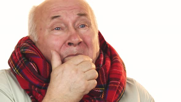 Sick and Ill Senior Man Wearing a Scarf Coughing Looking Tired