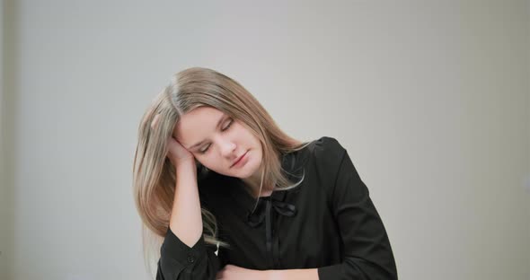 Bored Student with Long Hair Yawns Covering Mouth with Hand