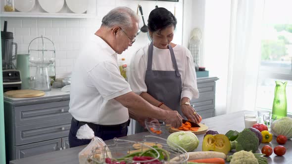 Senior Asian Couple at Kitchen Counter