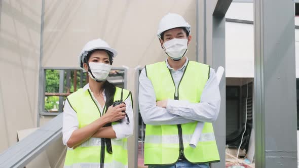 Asian construction workers people wearing protective face mask onsite of architecture due to covid19