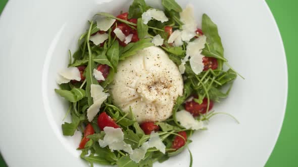 Vertical video: Mozzarella with salad in a plate