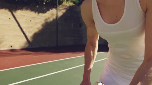 Woman playing tennis on a sunny day