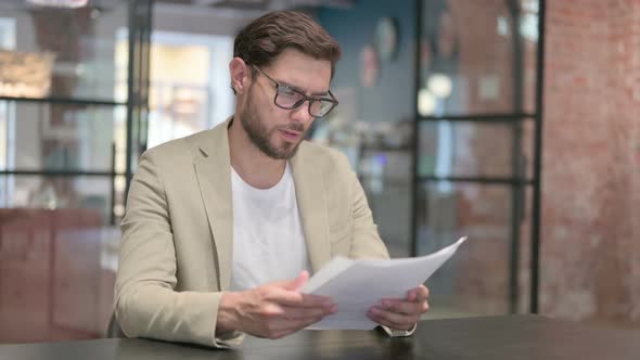 Young Man Reading Documents