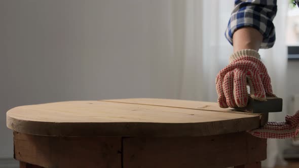 Woman Sanding Old Round Wooden Table with Sponge