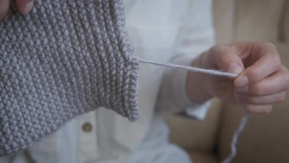 Woman with a yarn at home.