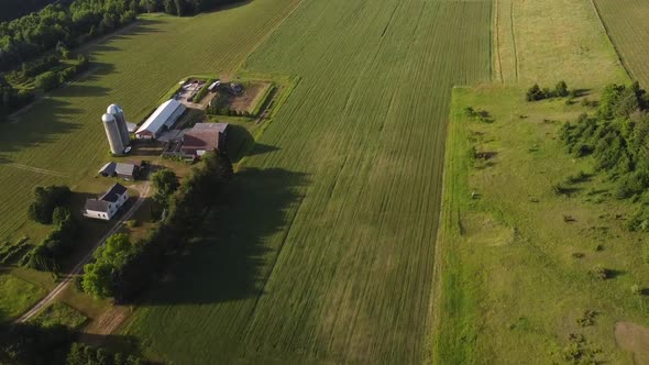 Silo And Farmhouse In The Lush Cherry Orchard In Leelanau County, Michigan - aerial