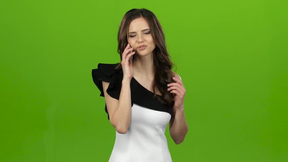 Brunette Picks Up the Phone, Dials the Number She Wants and Rings. Green Screen