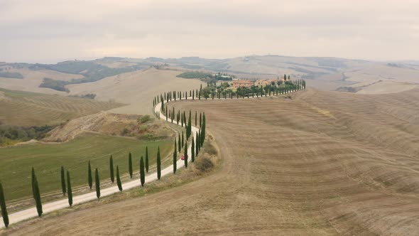 Aerial view of small road crossing mountain countryside landscape, Italy.