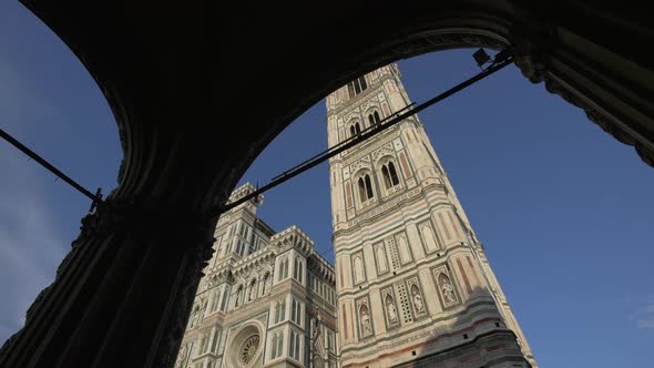 A cathedral facade seen from an arched portico