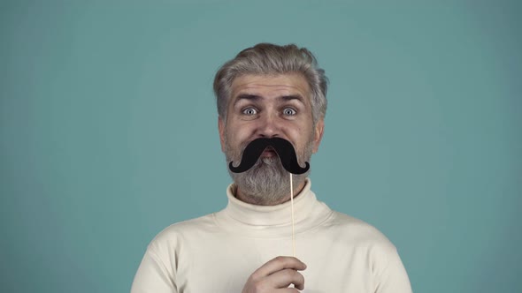 Man with Paper Mustache. Bearded Funny Hipster. Face of Man with Different Emotions. Excited Guy