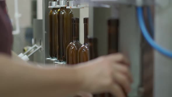 Wine Cork is Inserted Into the Bottle on a Machine