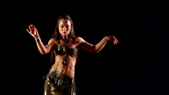 Sexy Woman Is Dancing Exotic Oriental Dance in Dark Studio