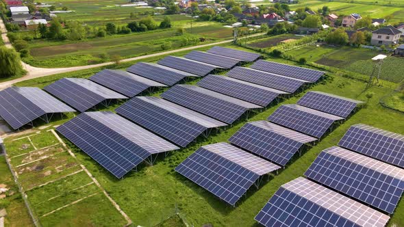 Aerial view of large sustainable electrical power plant with rows of solar photovoltaic panels