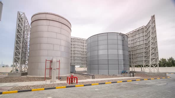 Two Silver Water Tanks with Fence Timelapse