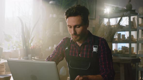 Man Is Working at Laptop