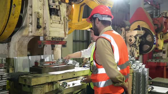 Two young engineers Testing and verifying the operation of the machines