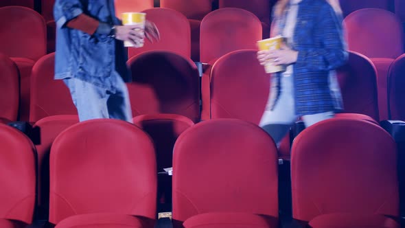 A Man and a Woman are Getting Comfortable at the Cinema