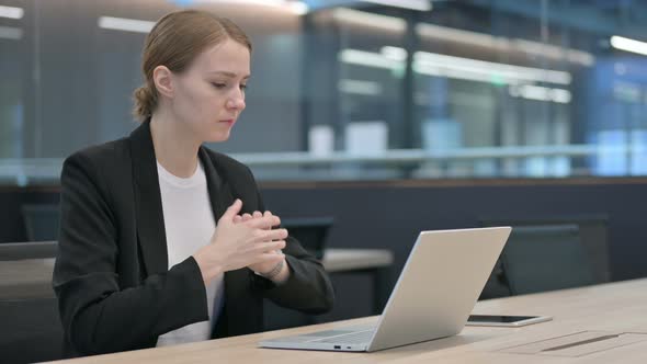 Businesswoman Having Wrist Pain While Typing on Laptop