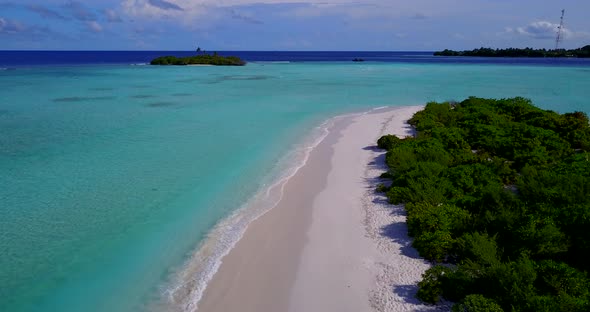 Luxury birds eye tourism shot of a white sand paradise beach and blue ocean background in colorful 4