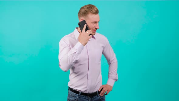 Happy Handsome Blonde Man Having a Pleasant Mobile Conversation.