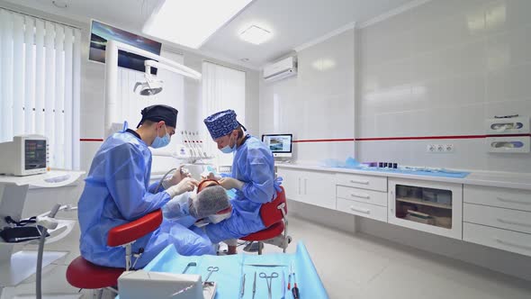 Woman at the dentist's visit. Professional stomatologist treats patient's teeth. 