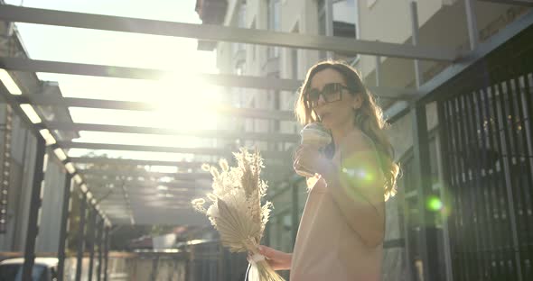 Young Beautiful Girl Holding a Bouquet of Flowers