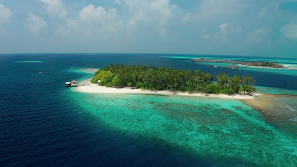 Scenic aerial drone flight over coral reef in the ocean in Maldives