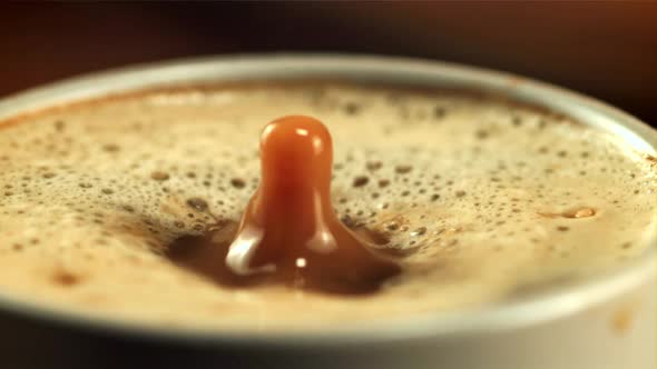 A Drop of Foam Falls Into a Cup of Coffee