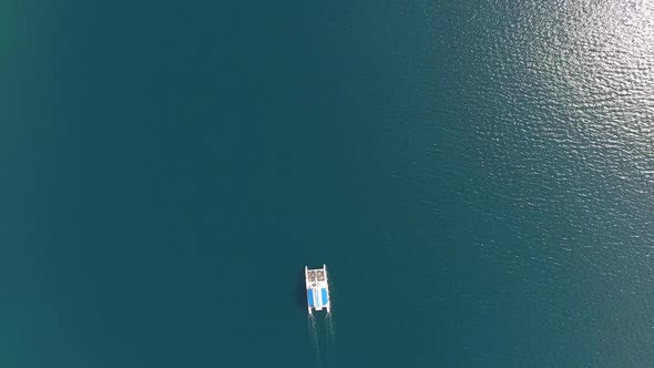 Lone Sailboat on the Sea Surface. Aerial Top View