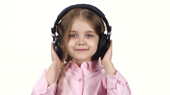 Little Girl Listens Music on Headphones and Dances, Close Ups