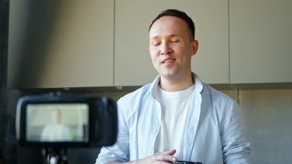 Professional blogger man cyborg with artificial high tech hand talks at online stream